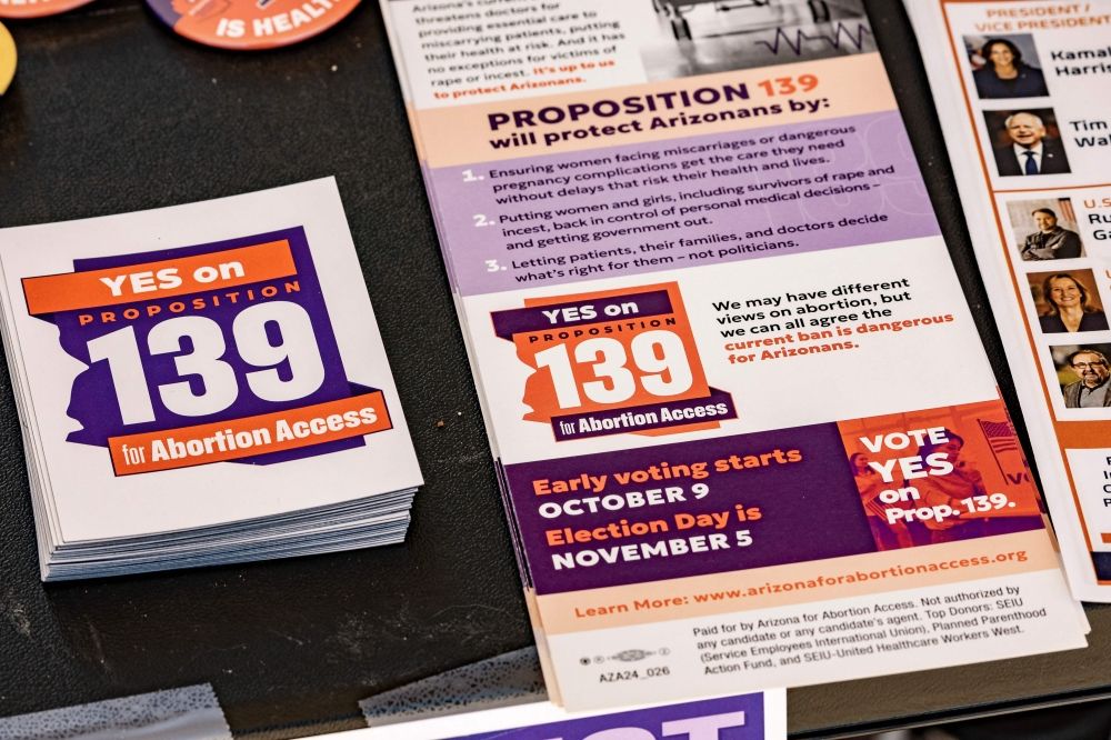 A table with literature calling for a YES vote on proposition 139, the right to abortion initiative, is displayed by members of Arizona List, an association made to empower and elect progressive pro-choice Democratic women leaders, at the entrance to the Murphy-Wilmot Library in Tucson, Arizona, October 16, 2024. — AFP pic
